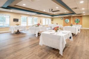 Spacious dining area with flower centerpieces at Arbor Post Acute.