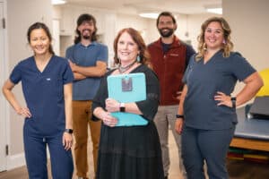 several nurses in the hallway of Arbor Post-Acute
