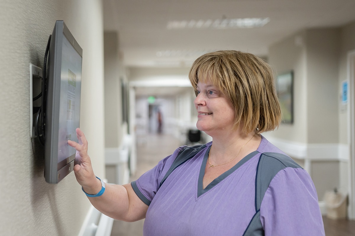 a nurse in the hallway at Arbor Post Acute