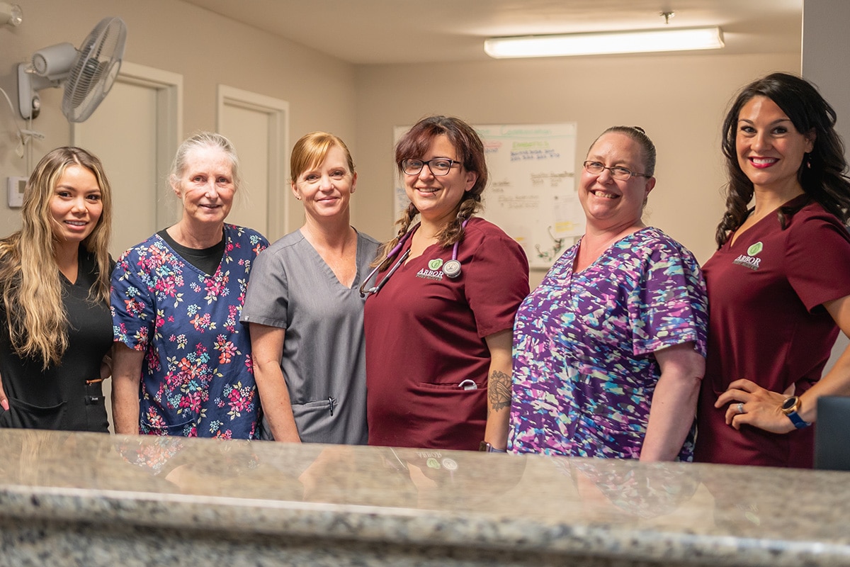 several nurses in the nurses station of Arbor Post-Acute